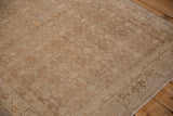 Muted beige and sand tones of the Herati pattern showing the distressed rug's low, even pile.