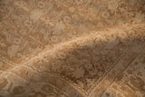 Textured, worn pile of a vintage Bijar rug showing the knot heads in shades of sand and beige.