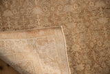 The hand-knotted back and machine-bound edge of a distressed vintage Bijar rug.