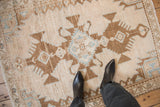 Serrated triple medallion in brown and powder blue on a vintage distressed Hamadan rug.