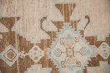 Serrated medallion detail in powder blue and brown on an evenly worn vintage Hamadan rug pile.