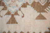 The even wear and visible knot heads of a hand-knotted, distressed Persian rug pile.