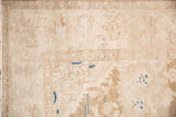 Worn, low pile on the corner spandrel and palmette border of a distressed beige Hamadan carpet.