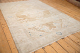 Angled perspective of a vintage Hamadan rug showing heavy abrashes over its floral design.