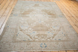 High-angle view of a distressed Hamadan rug showing its traditional medallion and decorative wear.