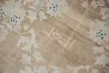 Woven date 1353 in ivory on the time-softened beige pile of a vintage Persian Hamadan carpet.