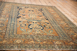 Angled perspective of a fine antique Tabriz highlights its time-softened tones and low pile.