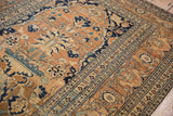 Angled view of a fine Tabriz rug's scrolling vine border and oversized floral palmettes in the field.
