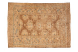 Vintage Afghan rug displaying a geometric lattice of guls in coffee brown, dusty blue, and ivory tones.