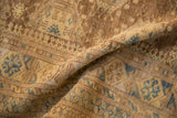 A vintage Afghan rug folded to show the dense, hand-knotted pile and geometric pattern.