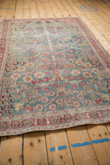 Perspective view of the distressed vintage rug's sprawling Tree of Life design in blue and red.