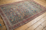 Full view of a vintage distressed Meshed rug with a sprawling Tree of Life motif.