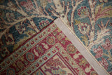 Back of the vintage Meshed rug showing the hand-knotted construction and secured edge.