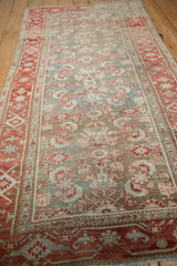 Angled view of a vintage Malayer rug highlighting its decorative wear and heavy abrashes.