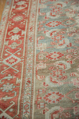 Soft, worn pile showing the pale red crab border and dusty blue Herati field on a vintage Malayer rug.