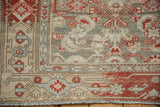 Heavy abrashes over the Herati field and crab style border of a distressed Persian rug.