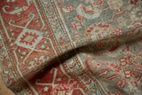 Soft, pliable drape of a distressed vintage Malayer rug showing its worn, hand-knotted pile.