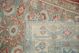 Corner view contrasting the distressed pile with the hand-knotted foundation of the vintage rug.
