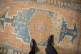 Geometric sky blue, sand, and magenta patterns on the distressed vintage Persian rug.