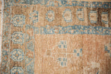 Distressed vintage Northwest Persian rug detail: sky blue and sand tribal patterns, knot head wear.