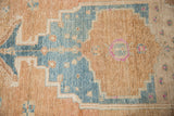 Distressed pile texture of vintage Northwest Persian rug with sky blue and sand motifs.