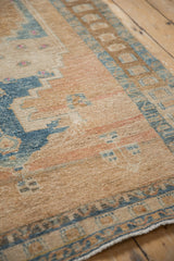 Distressed vintage Northwest Persian rug showing worn knot heads, sand, sky blue geometric motifs.