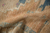 Distressed pile texture of a vintage Persian rug, revealing sandy, sky blue, and magenta tones.