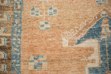 Vintage distressed pile texture with geometric motifs in sand, sky blue, and beige.