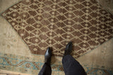 Distressed antique Hamadan rug with chocolate brown lattice, antique ivory seeds, and dusty blue border.