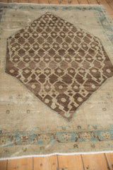Antique Hamadan rug: chocolate brown lattice vines, minor seed elements on abrashed ivory with visible wear.