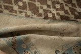Distressed Hamadan rug texture with folded abrashed ground and serrated blue border detail.