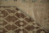 Antique Hamadan rug detail: worn chocolate brown lattice, platinum tones, and sky blue line.