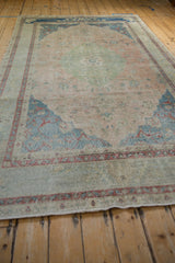 Textured pile of the vintage Turkish Sivas rug, with faded rose and dusty blue floral designs.