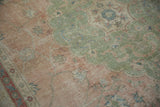 Distressed Sivas carpet detail showing pale rose, jade green, mostly even wear to knot heads.