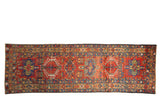 Vintage Karaja runner: brick red field, three geometric medallions, and floral motifs.
