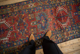 Karaja runner with brick red, sapphire blue geometric medallions and hook-and-latch motifs.