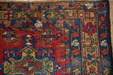 Karaja runner border with pale gold germinating blossoms, sapphire blue, and brick red.