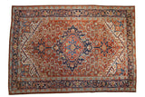 Vintage Heriz Persian carpet with a serrated diamond medallion in brick red, navy blue, and jade green.