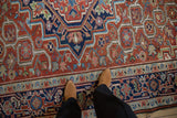 Serrated diamond medallion and turtle samovar border design on a hand-knotted vintage Heriz carpet.