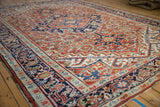A low angle perspective of a vintage Heriz carpet showing its stepped medallion and complex geometric field.