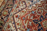 Corner detail showing the turtle samovar and Herati border on a vintage Heriz carpet.