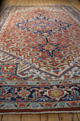 Low angle perspective of a vintage Heriz carpet's geometric medallion and turtle design border.