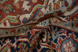 Folded view of a vintage Heriz carpet, detailing the low pile and hand-knotted texture.