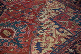 Close view of a vintage Heriz carpet's main border with geometric turtle and floral motifs.