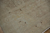 Distressed Sarouk rug detail showing worn pile, faint foundation, and fringed edge.