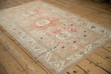 Distressed Anatolian rug detail with geometric patterns, navy X accents, and time-softened pile.