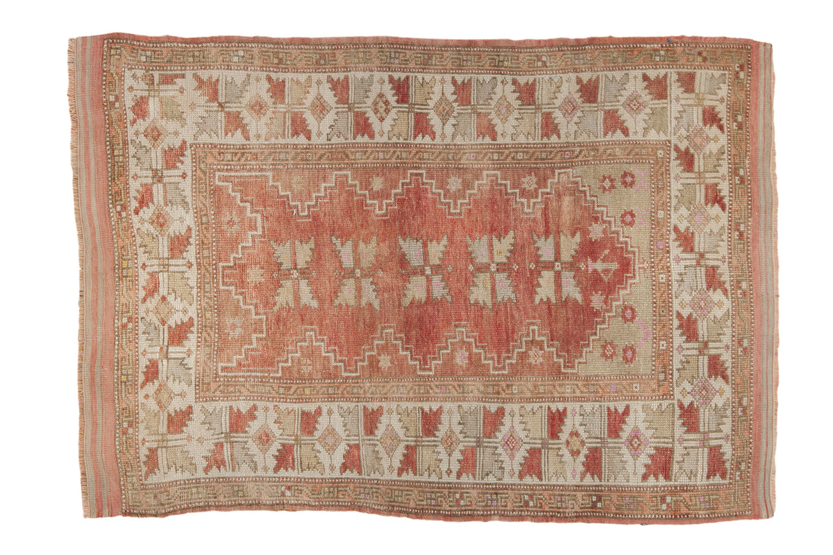 Distressed Turkish Melas rug with dusty raspberry red field, serrated leaf medallions, serpent borders.