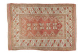 Distressed Turkish Melas rug with dusty raspberry red field, serrated leaf medallions, serpent borders.