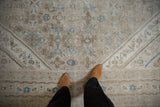 Distressed low pile revealing the Herati motif and corner spandrel in sand and powder blue.