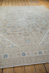 Angled perspective on the distressed Bibikabad rug's pile showing its mostly even wear.